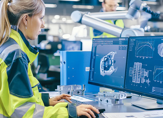 women in safety jacket with desktop