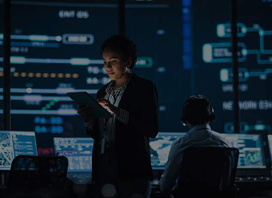 Women looking at tablet in headquarter room